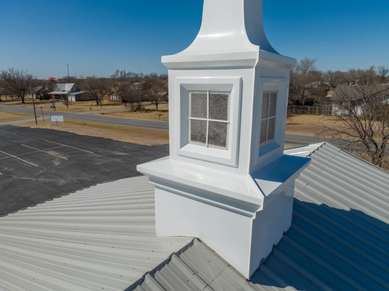 Close-up of steeple and metal roof