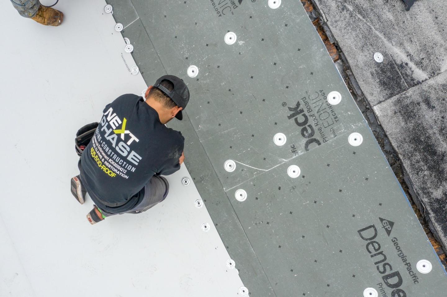 Worker inspecting a flat roof