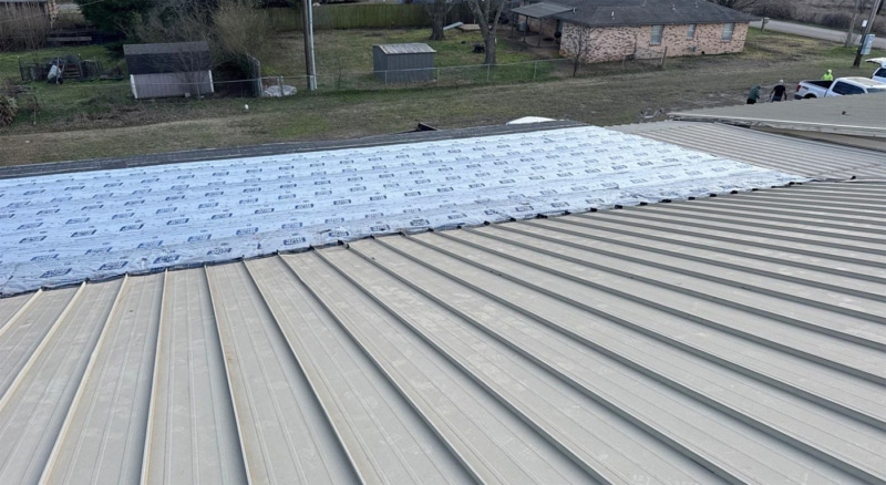Temporary repairs to the metal roof on the church in Durant.
