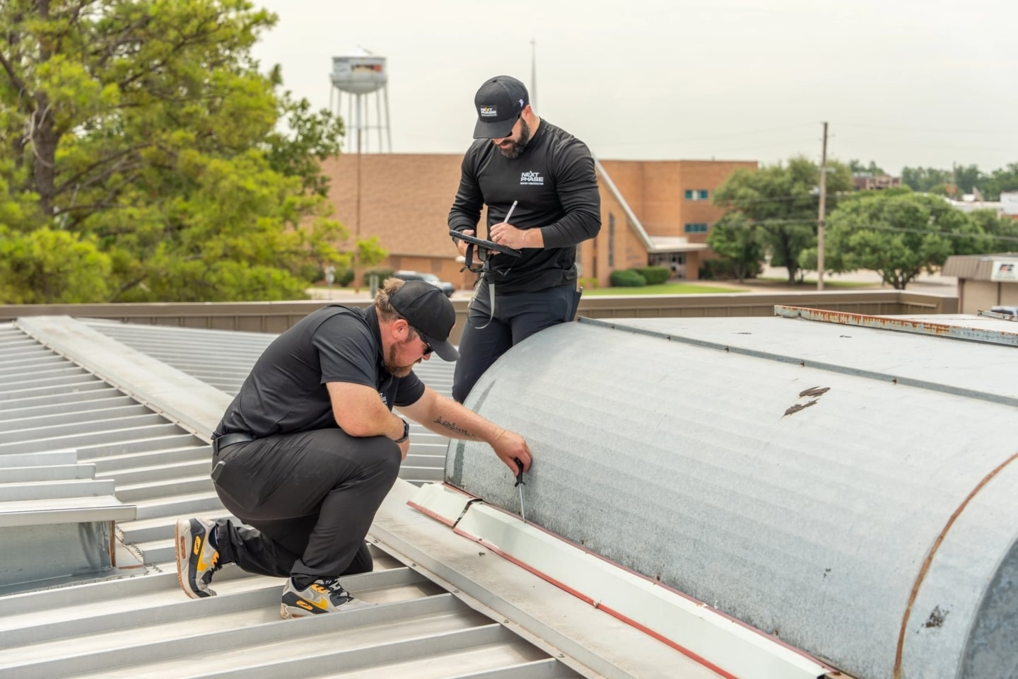 Workers inspecting a commercial roof