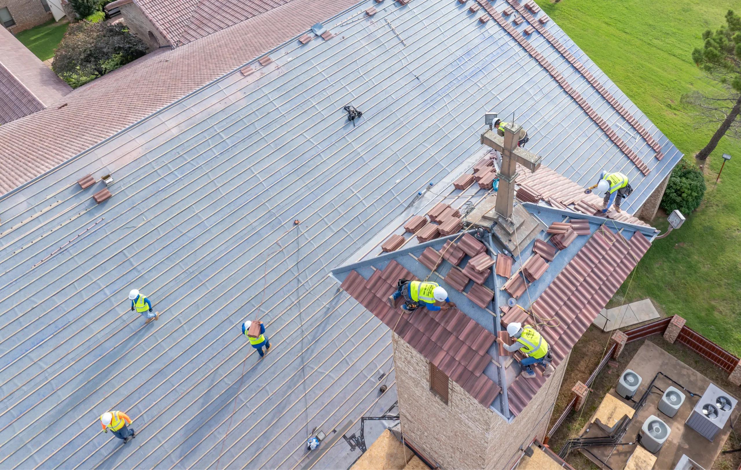 Tile roof installation underway on historic church building