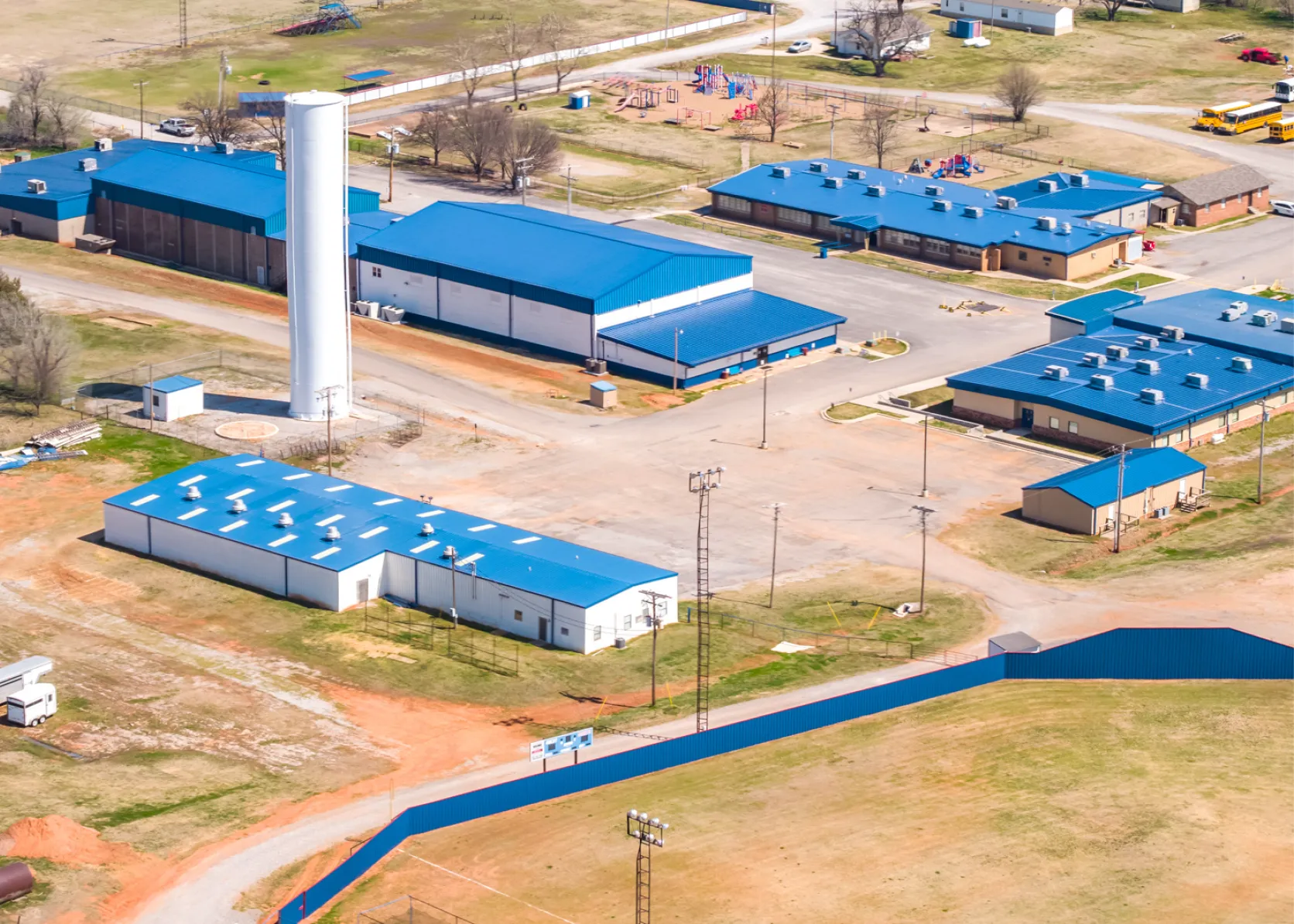 Blue metal roofing installed across multi-building campus