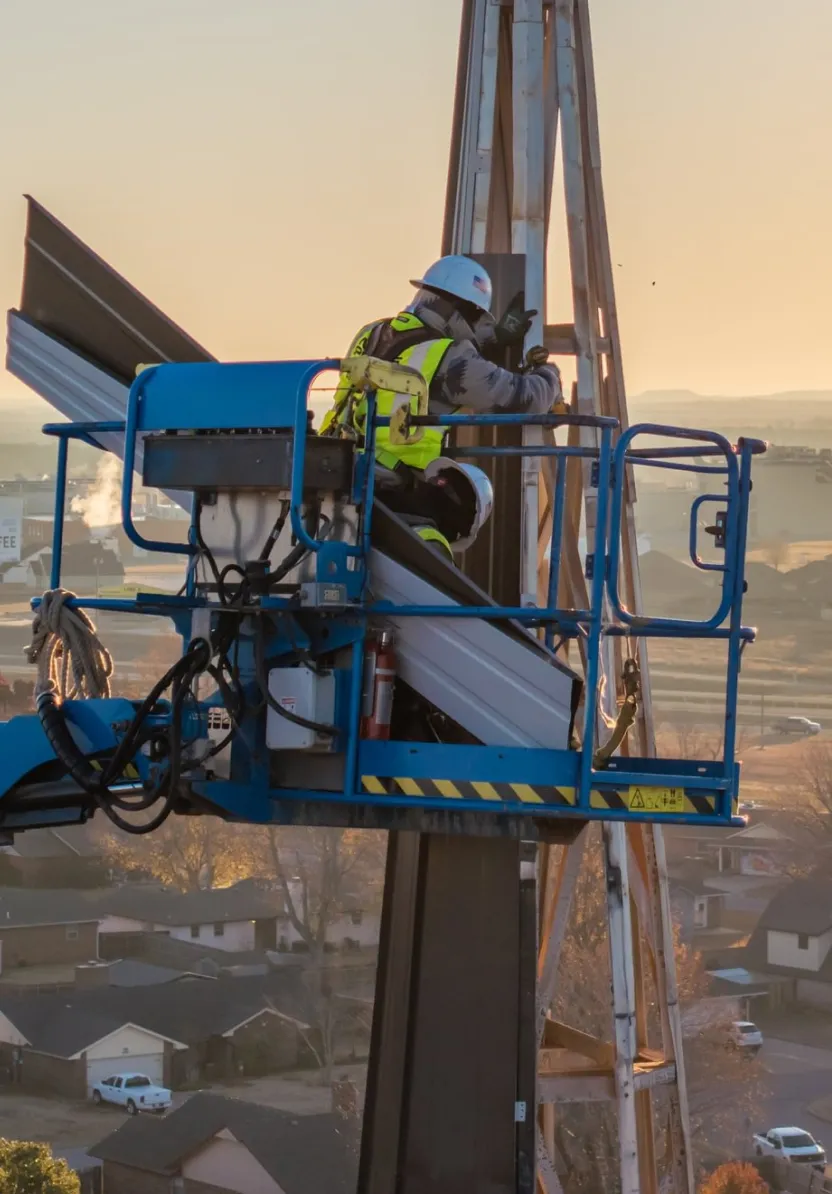 Crew performing steeple repair on historic church building