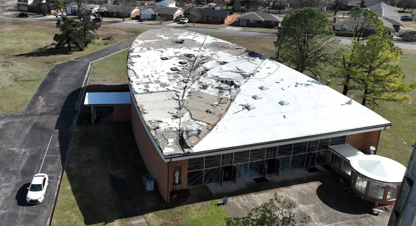 Tornado damage to the flat roof of a church