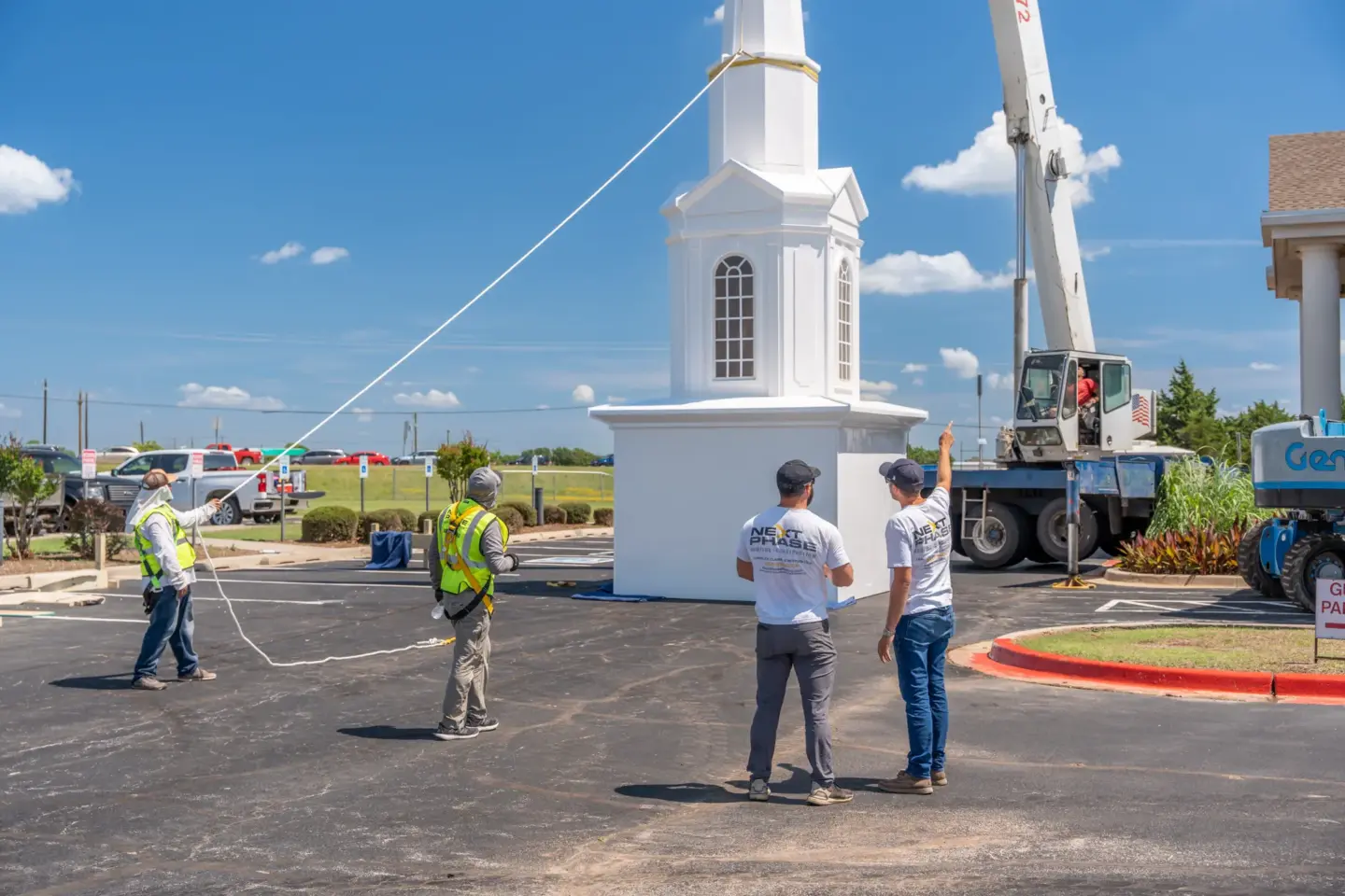Workers discussing a steeple