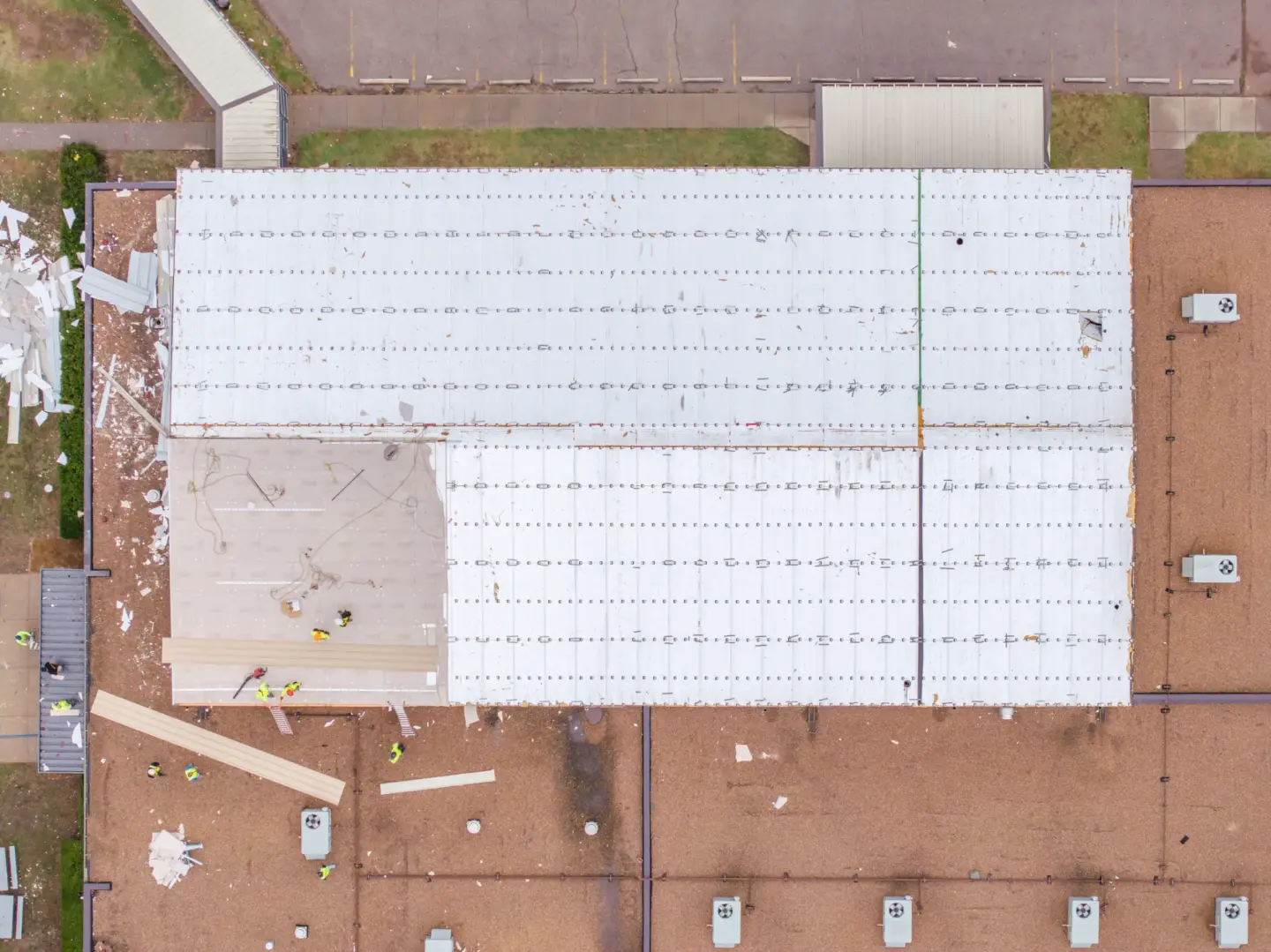 Aerial view of a school roof being temporarily repaired