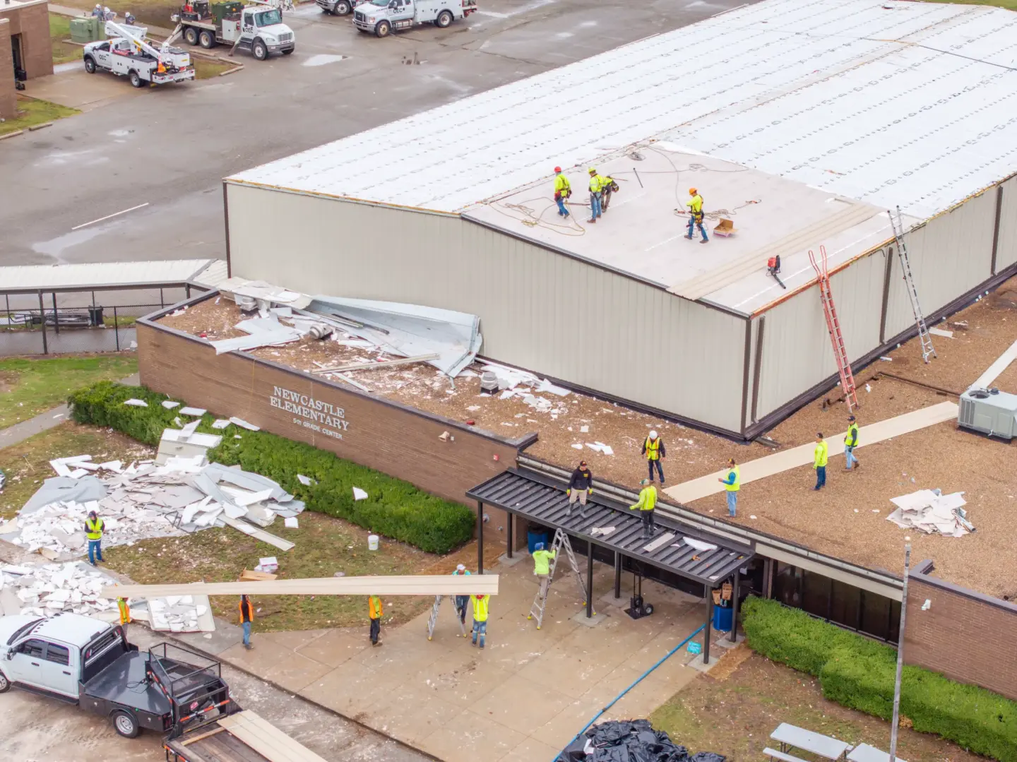 Crew temporarily repairing a school roof