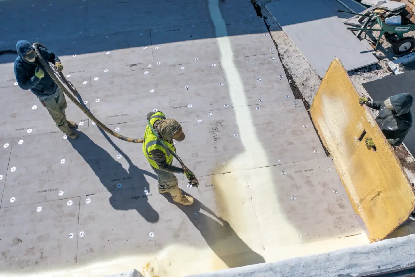 Worker spraying foam on a flat roof