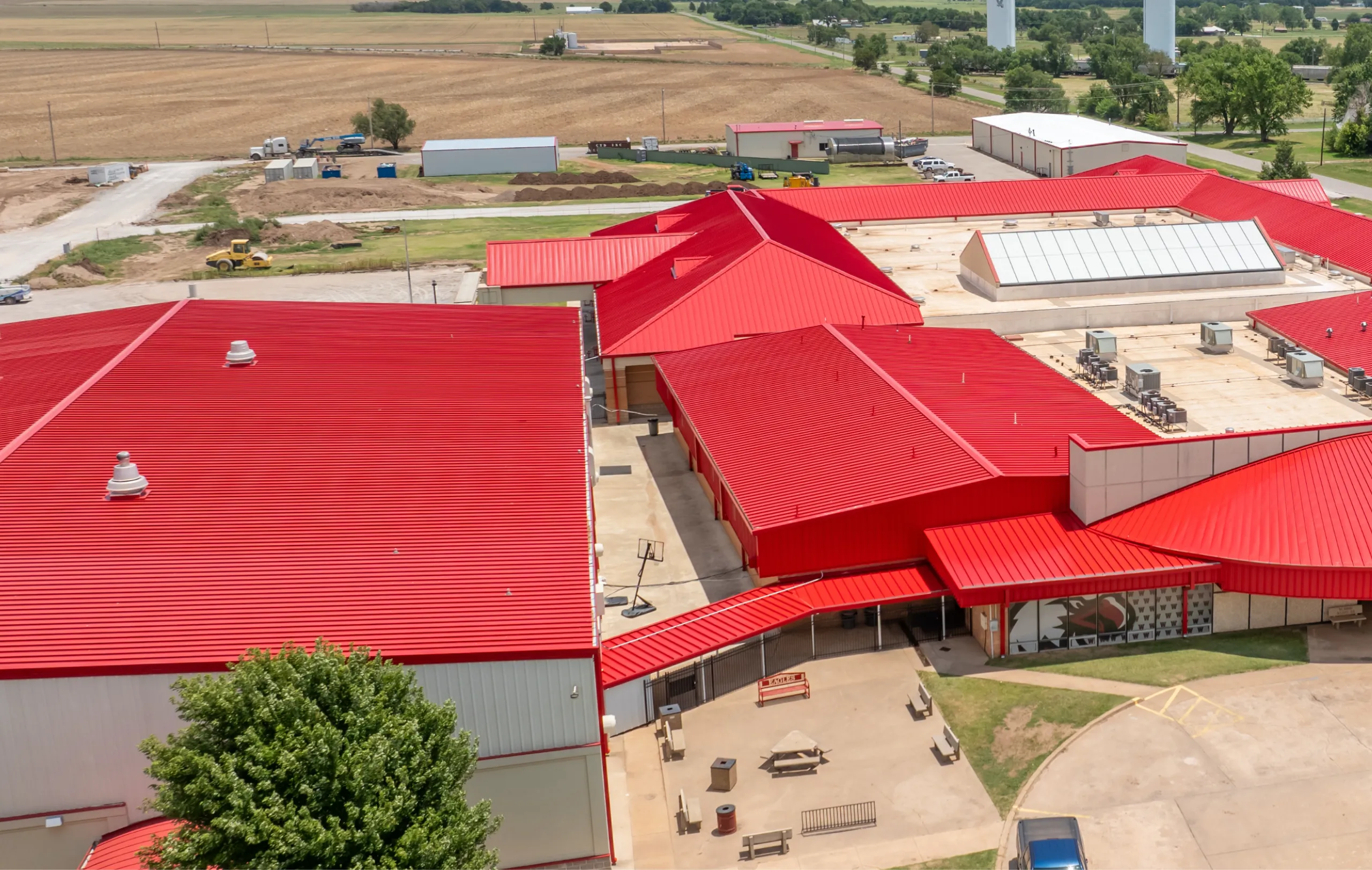 Large scale metal roofing installation on school campus