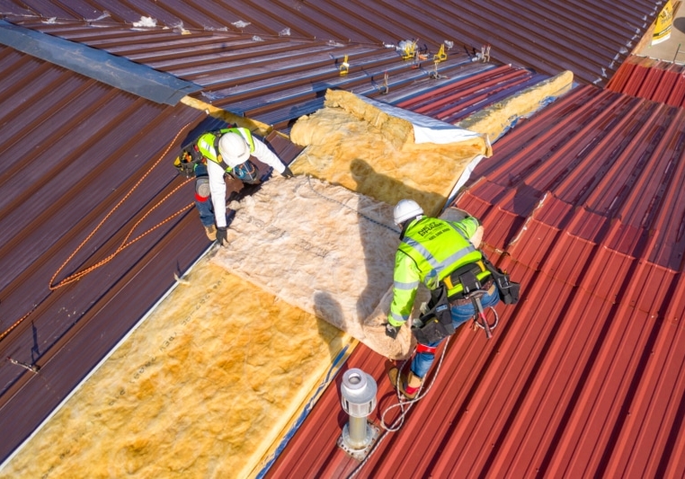 Insulation and metal roof installation for commercial property