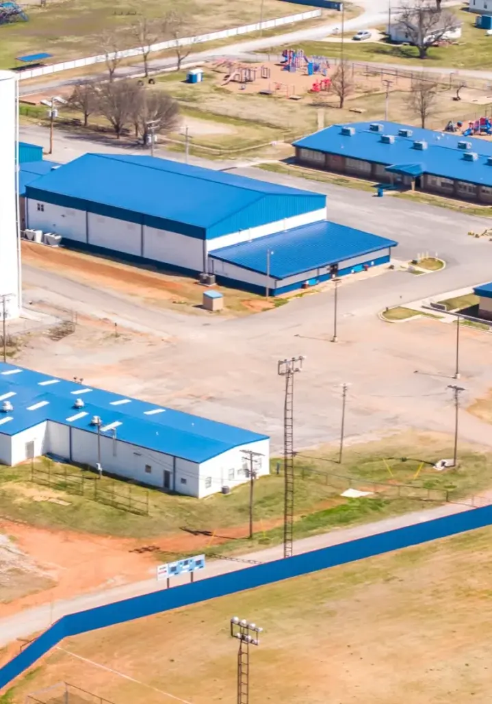 Blue metal roofing installed across multi-building campus